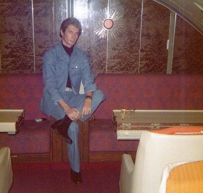 1970s A customer poses in the upper deck dinning room of a Pan Am 747 on a short flight not offering dinning service.